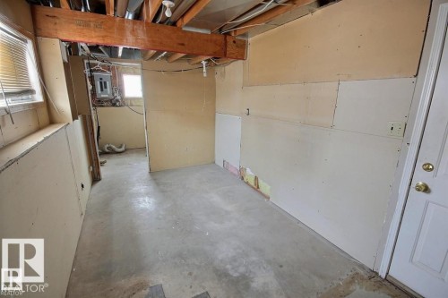 Unfinished lower level with exposed ceiling joists and concrete flooring - 9457 156 Street, Edmonton, AB 