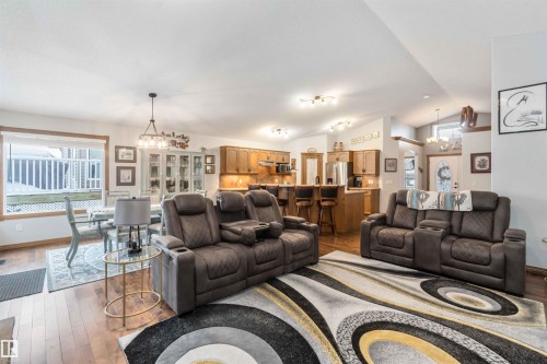 The property features an open-concept living space with hardwood flooring and recessed lighting - 61 Linkside Blvd, Spruce Grove, AB 