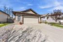 Single-story home featuring horizontal siding and a two-car garage - 61 Linkside Blvd, Spruce Grove, AB 