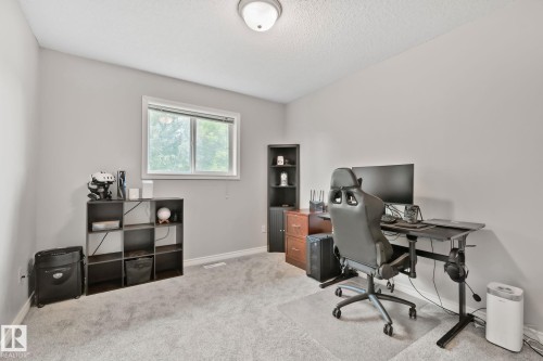 Carpeted room with a ceiling-mounted light fixture and a window - 5161 54 Avenue, Redwater, AB - Indoor Photo Showing Office