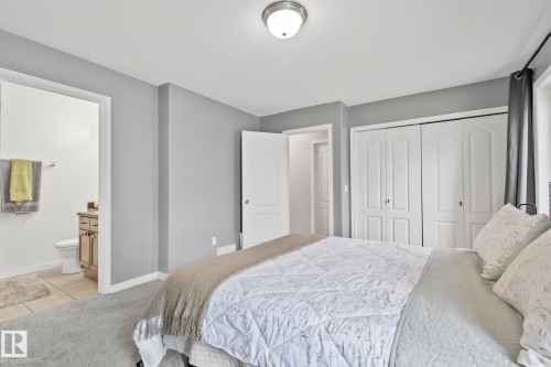 Bedroom with neutral grey walls, grey carpeting, and white trim - 5161 54 Avenue, Redwater, AB - Indoor Photo Showing Bedroom