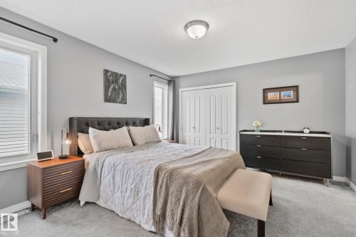 Spacious bedroom featuring light gray wall paint, light-colored carpeting, white trim, and a ceiling-mounted light fixture - 5161 54 Avenue, Redwater, AB - Indoor Photo Showing Bedroom