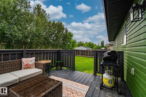 Expansive outdoor deck featuring dark-stained wood planks and black railing, offering open-air enjoyment - 5161 54 Avenue, Redwater, AB - Outdoor With Deck Patio Veranda With Exterior