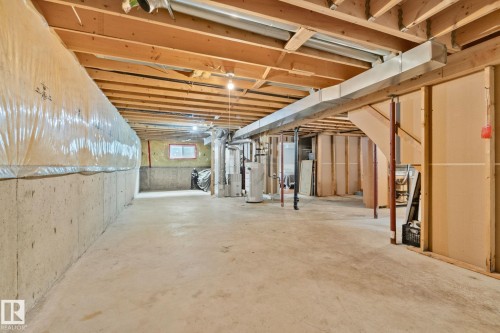 Unfinished basement featuring concrete walls and flooring, exposed wood joists, and visible ductwork - 5161 54 Avenue, Redwater, AB - Indoor Photo Showing Basement