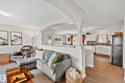 Living area featuring an arched doorway and a half-wall with a decorative column - 5161 54 Avenue, Redwater, AB - Indoor Photo Showing Living Room