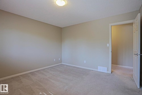 Neutral-toned walls complement the light-colored carpet flooring - 6215 60 Street, Beaumont, AB - Indoor Photo Showing Other Room