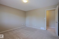 Neutral-toned walls complement the light-colored carpet flooring - 