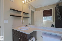 Bathroom vanity featuring a white oval sink, chrome faucet, and integrated countertop - 