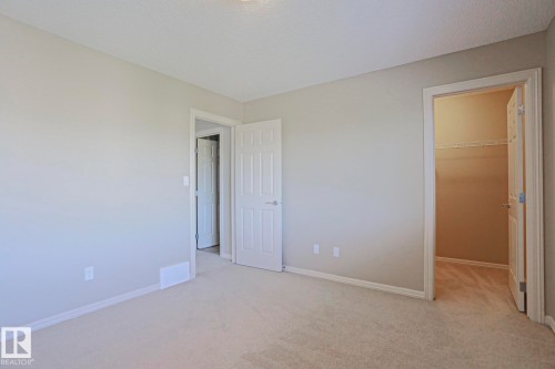 Room featuring light-colored carpet flooring, neutral wall paint, and white trim - 6215 60 Street, Beaumont, AB - Indoor Photo Showing Other Room