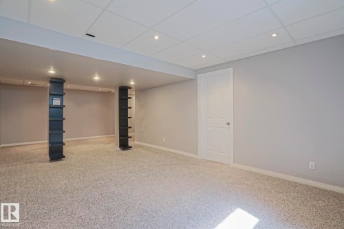Open concept room featuring recessed lighting, light gray walls, and textured carpeting - 6215 60 Street, Beaumont, AB - Indoor