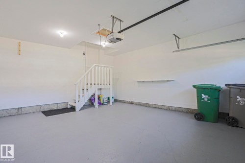 Spacious garage featuring a durable concrete floor and white painted walls - 6215 60 Street, Beaumont, AB - Indoor Photo Showing Garage