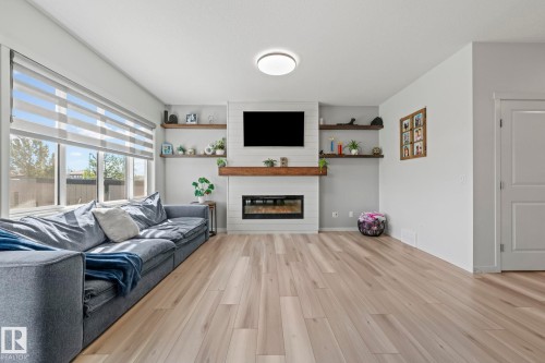 Bright living area featuring wide plank wood-finish flooring - 1931 Westerra Lane, Stony Plain, AB 