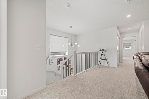 Upper-level landing featuring light-toned carpeting and white walls - 1931 Westerra Lane, Stony Plain, AB 