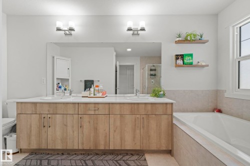 Dual vanity with wood-finish cabinetry and white countertops - 1931 Westerra Lane, Stony Plain, AB 