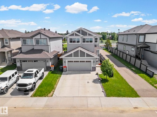 Contemporary two-story residence featuring a gray exterior with white trim accents and a dark shingle roof - 1931 Westerra Lane, Stony Plain, AB 