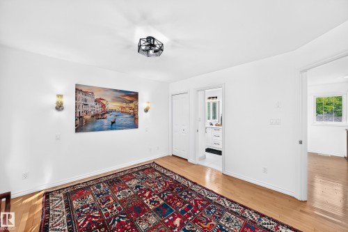 Light wood-finish flooring complements white walls - 10323 138 Street, Edmonton, AB 
