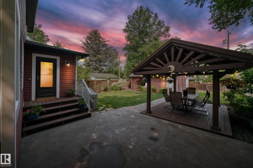 Covered outdoor living space featuring a wood-finish pergola - 10323 138 Street, Edmonton, AB 