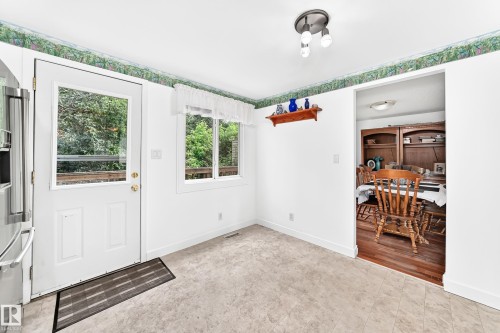 Eat-in kitchen featuring durable tile flooring and abundant natural light from the glass-panel door and window - 191 Ridgewood Terrace, St. Albert, AB 