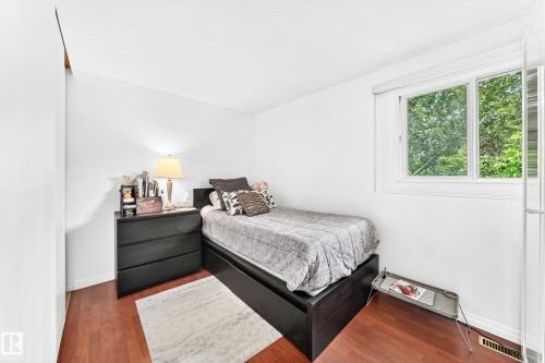 White walls and wood-finish flooring define this bright interior space, featuring a large window with natural light - 191 Ridgewood Terrace, St. Albert, AB 