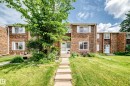 Brick townhouse exterior featuring white window trim and a stone-stepped pathway - 191 Ridgewood Terrace, St. Albert, AB 