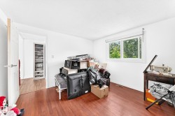 Bright room featuring wood-finish flooring and a white window frame - 