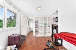 Wood-finish flooring with white walls and trim - 