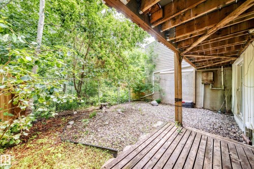 Wood deck with exposed joist ceiling featuring a gravel patio area and a partial privacy fence - 191 Ridgewood Terrace, St. Albert, AB 