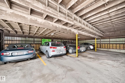 Covered parking garage featuring concrete construction and marked parking spaces - 191 Ridgewood Terrace, St. Albert, AB 