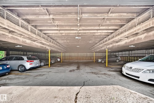 Covered parking structure featuring concrete construction and overhead lighting - 191 Ridgewood Terrace, St. Albert, AB 