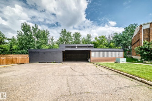 Exterior building featuring a black facade, vertical paneling, and a horizontal wood-finish accent - 191 Ridgewood Terrace, St. Albert, AB 