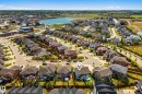 Aerial perspective of a residential neighborhood featuring a central lake - 70 James Crescent, St. Albert, AB 