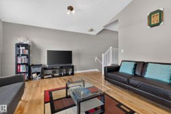 Living area featuring wood-finish flooring and neutral wall tones - 