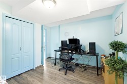 Room featuring wood-finish flooring, light blue walls, and a white textured ceiling - 
