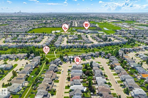Aerial perspective showcasing a residential neighborhood with extensive green spaces and established streetscapes - 14908 137 Street, Edmonton, AB 