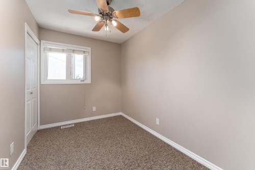 Interior room featuring neutral wall paint and textured carpeting - 16B Callingwood Court, Edmonton, AB 