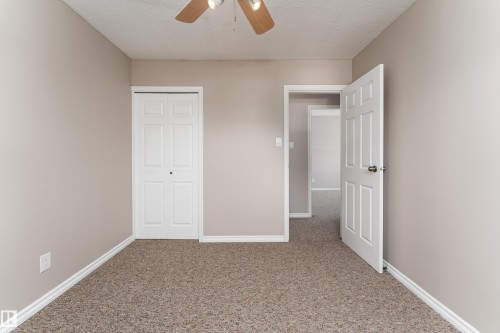 Room with textured carpeting and light neutral wall paint - 16B Callingwood Court, Edmonton, AB 