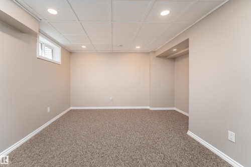 Spacious room featuring neutral paint, recessed lighting, drop ceiling, and plush carpeting - 16B Callingwood Court, Edmonton, AB 