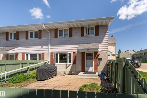 Two-story exterior with light-colored siding and brown shutters - 16B Callingwood Court, Edmonton, AB 