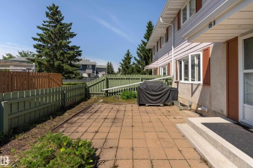 Private fenced patio area featuring concrete paver flooring - 16B Callingwood Court, Edmonton, AB 