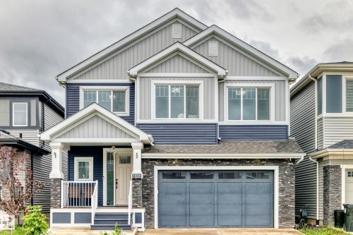 Contemporary two-story residence featuring a striking blue and light gray siding facade - 8710 Mayday Lane, Edmonton, AB 