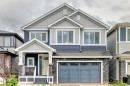 Contemporary two-story residence featuring a striking blue and light gray siding facade - 8710 Mayday Lane, Edmonton, AB 