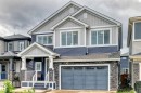 Contemporary two-story residence featuring a striking blue and gray siding facade - 8710 Mayday Lane, Edmonton, AB 