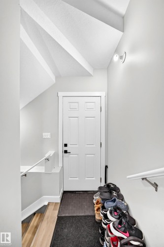 White paneled door with black hardware, flanked by light gray walls - 8710 Mayday Lane, Edmonton, AB 