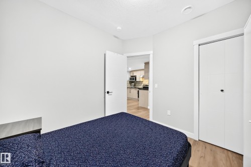 Interior room featuring light-toned walls and wood-finish flooring - 8710 Mayday Lane, Edmonton, AB 
