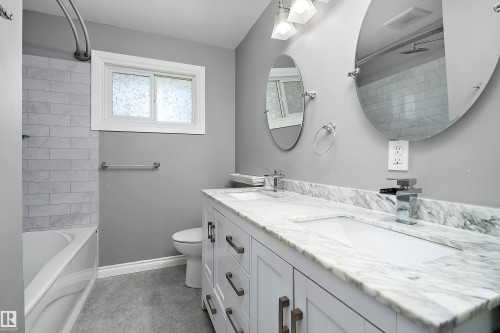 Double vanity with a stone countertop and dual undermount sinks - 5516 47A Avenue, Wetaskiwin, AB - Indoor Photo Showing Bathroom