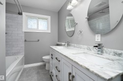 Double vanity with a stone countertop and dual undermount sinks - 