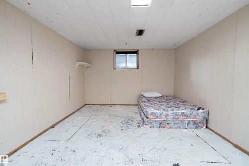 Room featuring paneled walls, a drop ceiling, and a single window - 5516 47A Avenue, Wetaskiwin, AB - Indoor Photo Showing Other Room