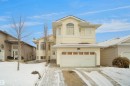 Two-story residence featuring light-colored siding, an integrated two-car garage, and a bay window - 4816 155 Ave, Edmonton, AB 