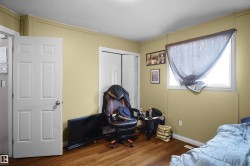 Room with wood-finish flooring, light-colored walls, and a white framed window - 