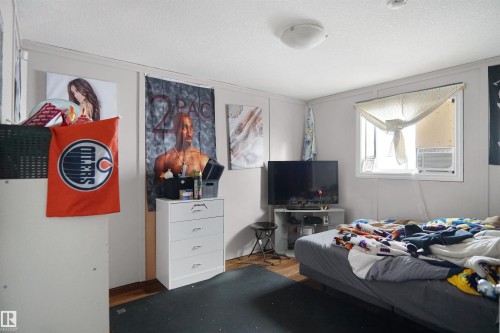 Bedroom with wood-finish flooring and a white ceiling - 4816 155 Ave, Edmonton, AB 